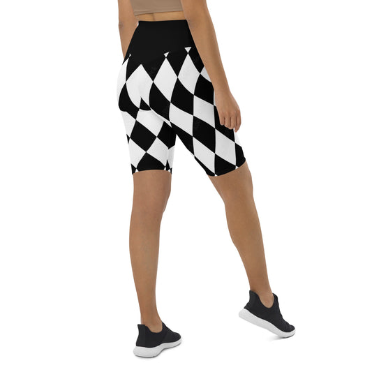 Woman wearing kallistii black and white harlequin active shorts with high waist and mid-thigh length