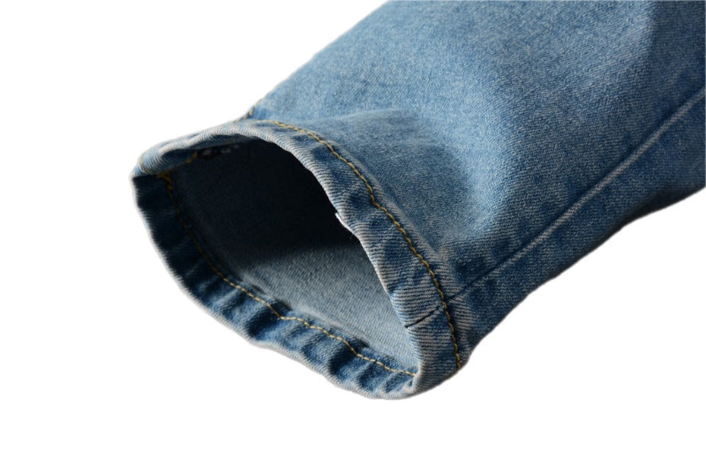 Close-up of cuff detail on trendy street style denim pants by kallistii in light blue wash