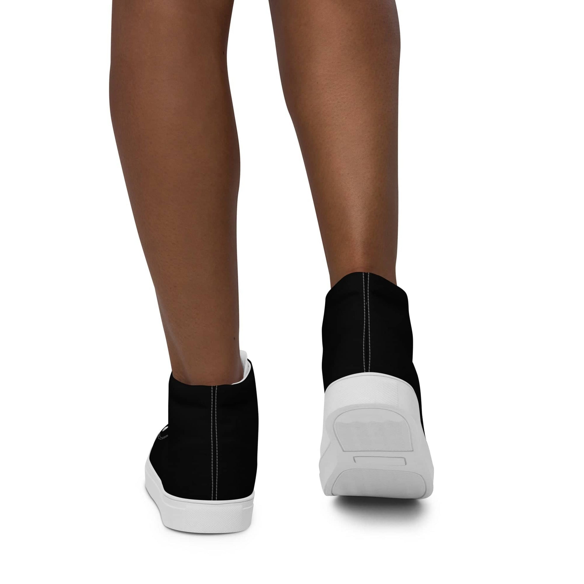 Black high-top shoes for women with white soles shown from back on model's feet