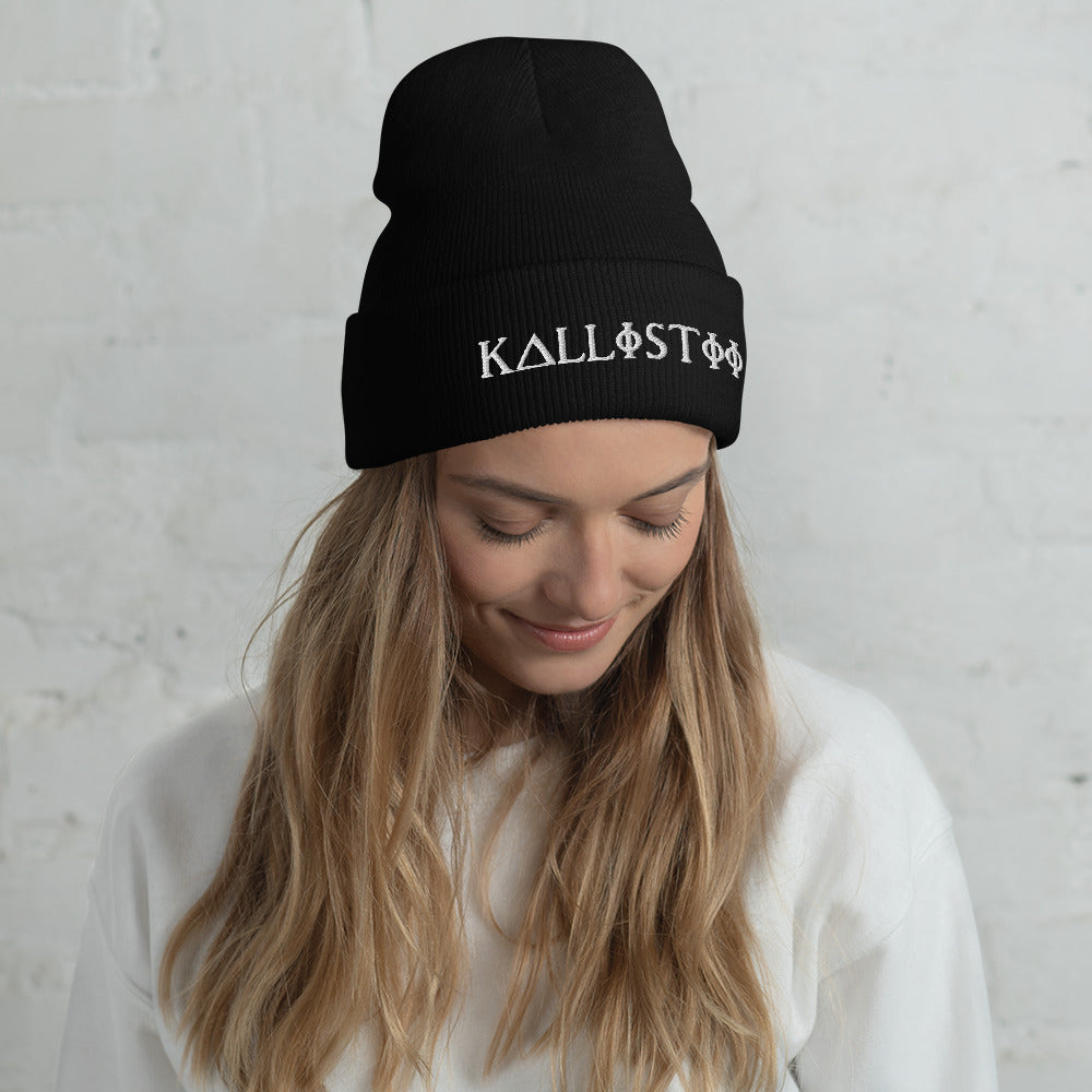 Woman wearing black KALLISTII embroidered beanie with white logo on folded cuff