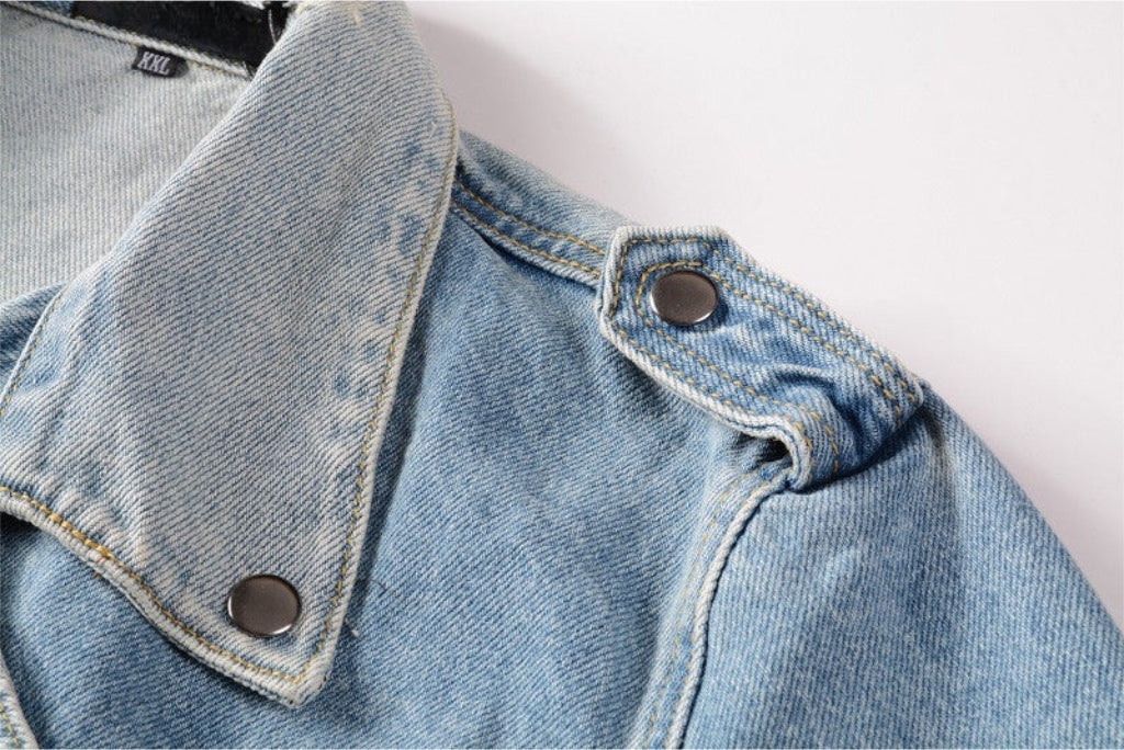 Close-up of blue denim motorcycle jacket collar and shoulder with metal snap buttons from kallistii