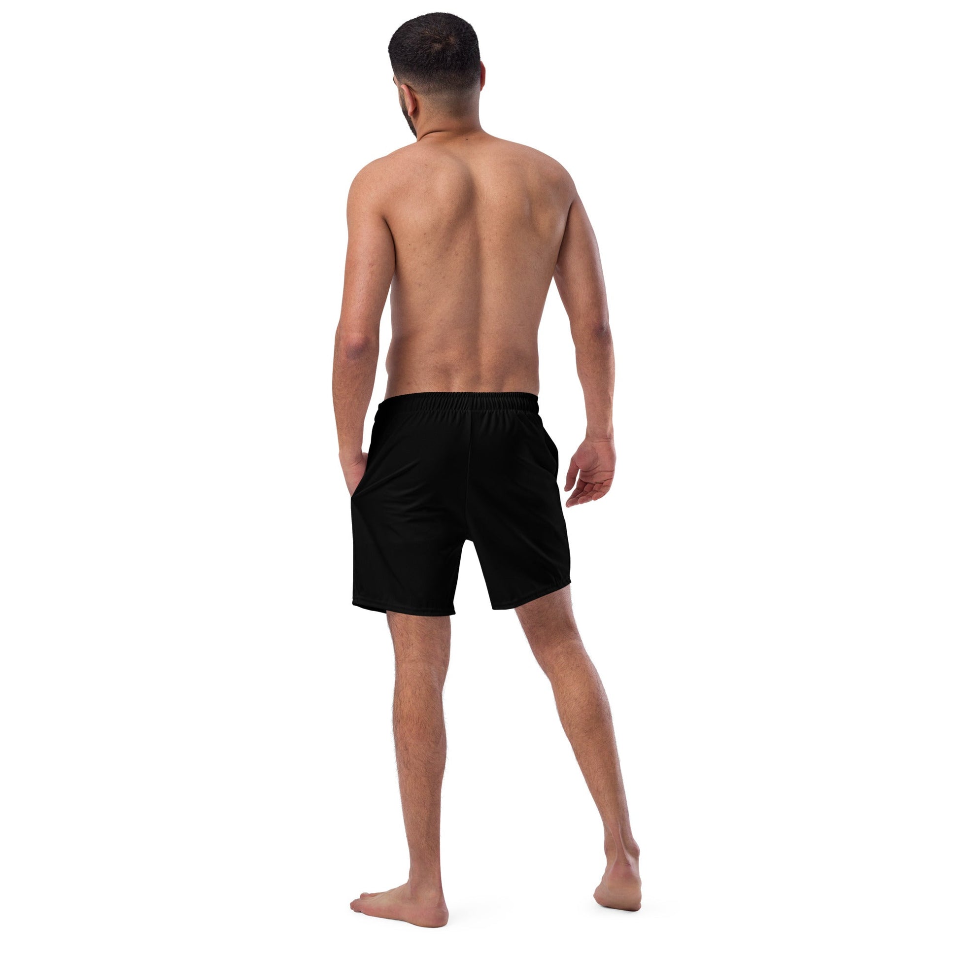 Back view of a man wearing black Hands of Eris swim trunks with an elastic waistband by kallistii