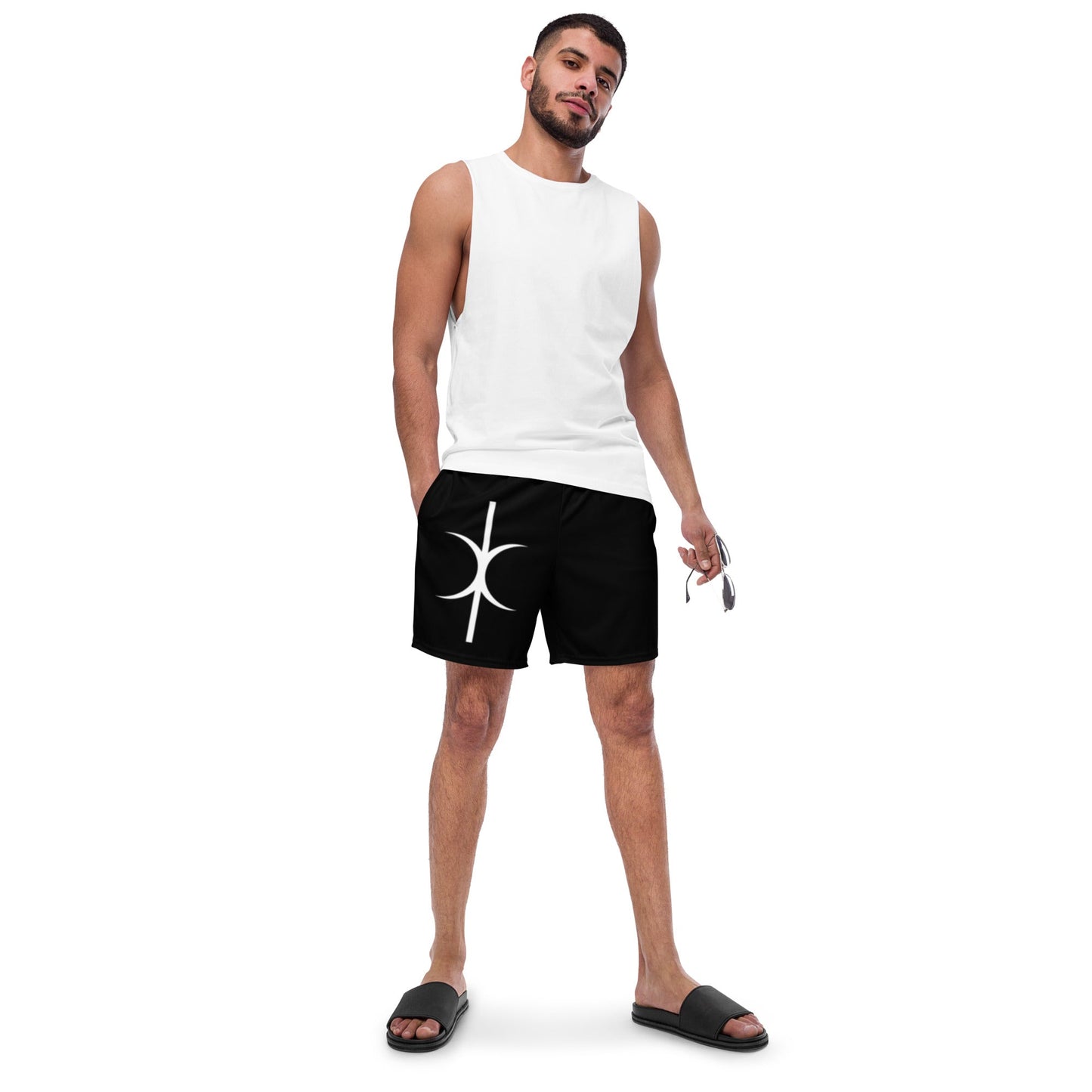 Man wearing black Hands of Eris swim trunks with white logo, paired with white sleeveless shirt and black slides