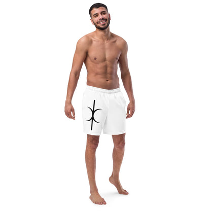 Man wearing white Hands of Eris swim trunks with black symbol design and elastic waistband