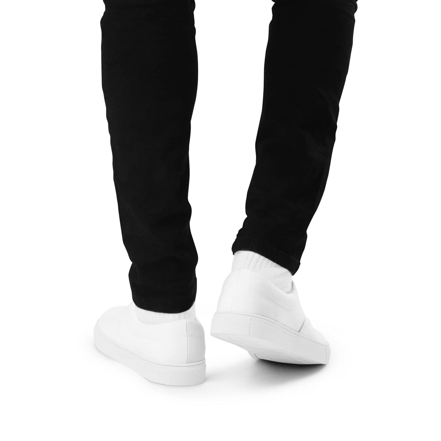 White stylish low top shoes for men worn with black pants against white background