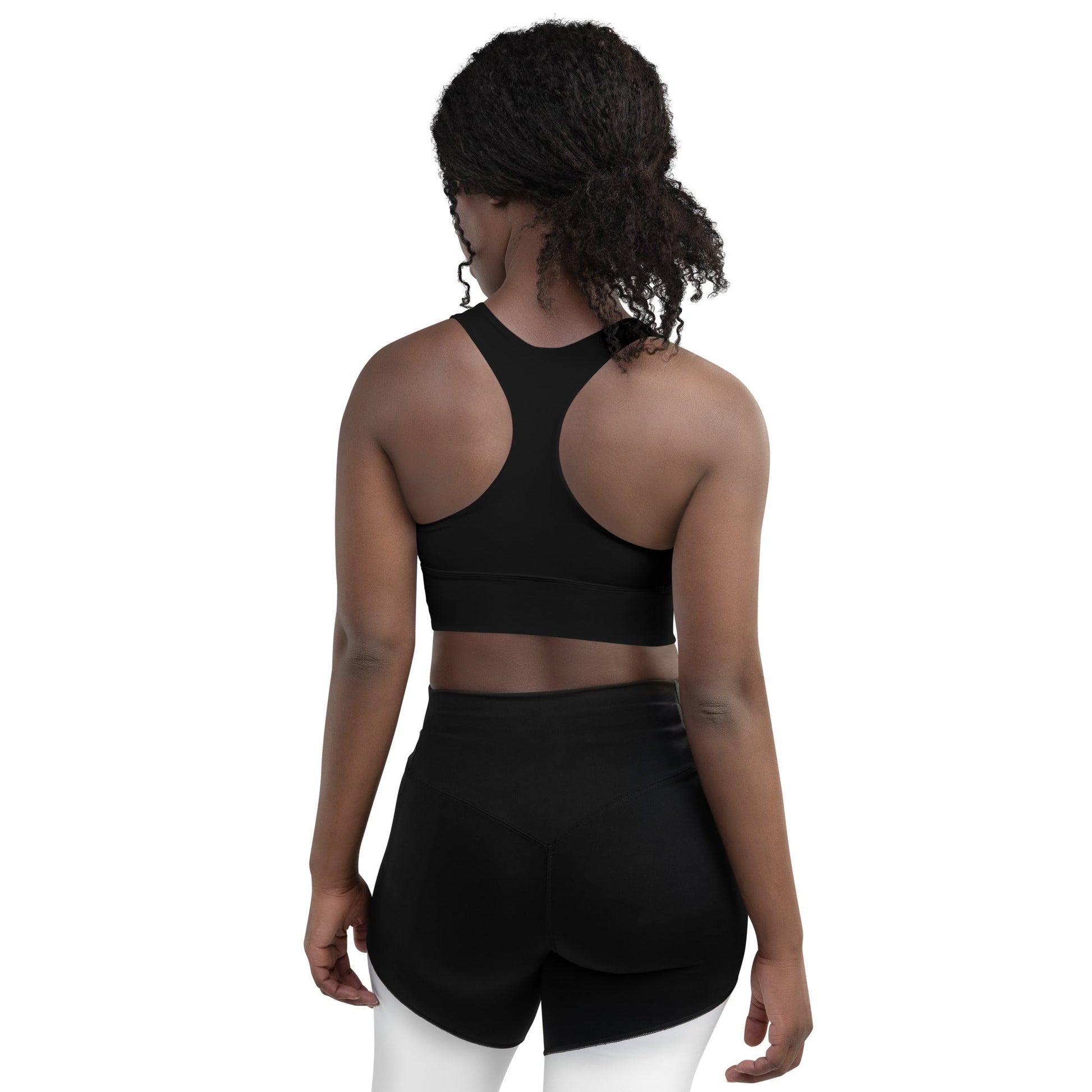 Back view of a woman wearing KALLISTII activewear sports bra and black shorts for workout