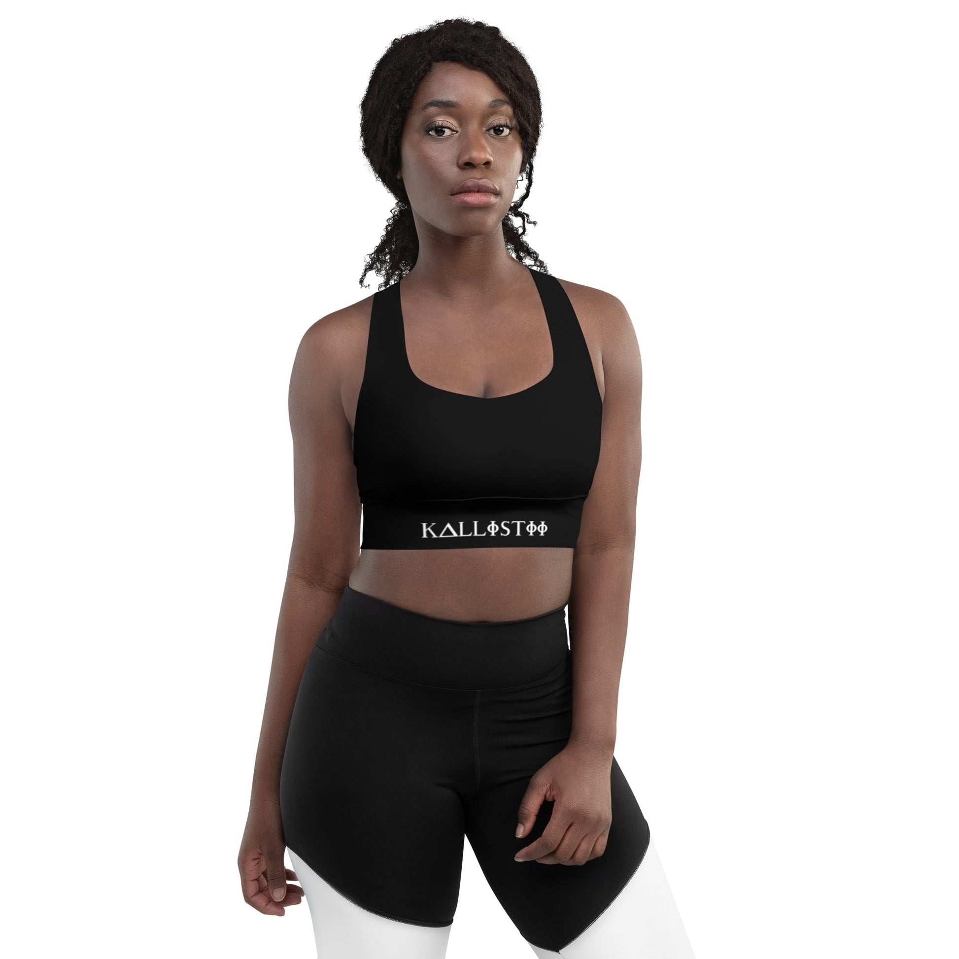 KALLISTII activewear sports bra in black modeled with matching high-waisted shorts on white background