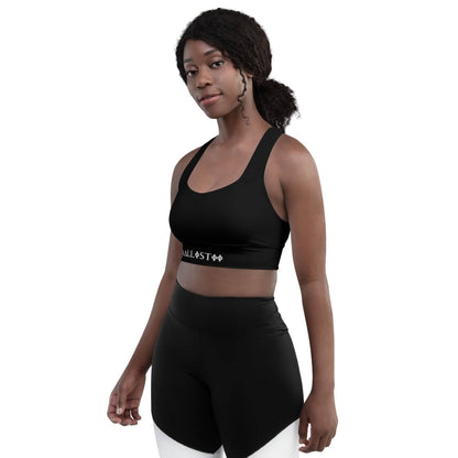 Woman wearing a black KALLISTII activewear sports bra with matching black and white leggings