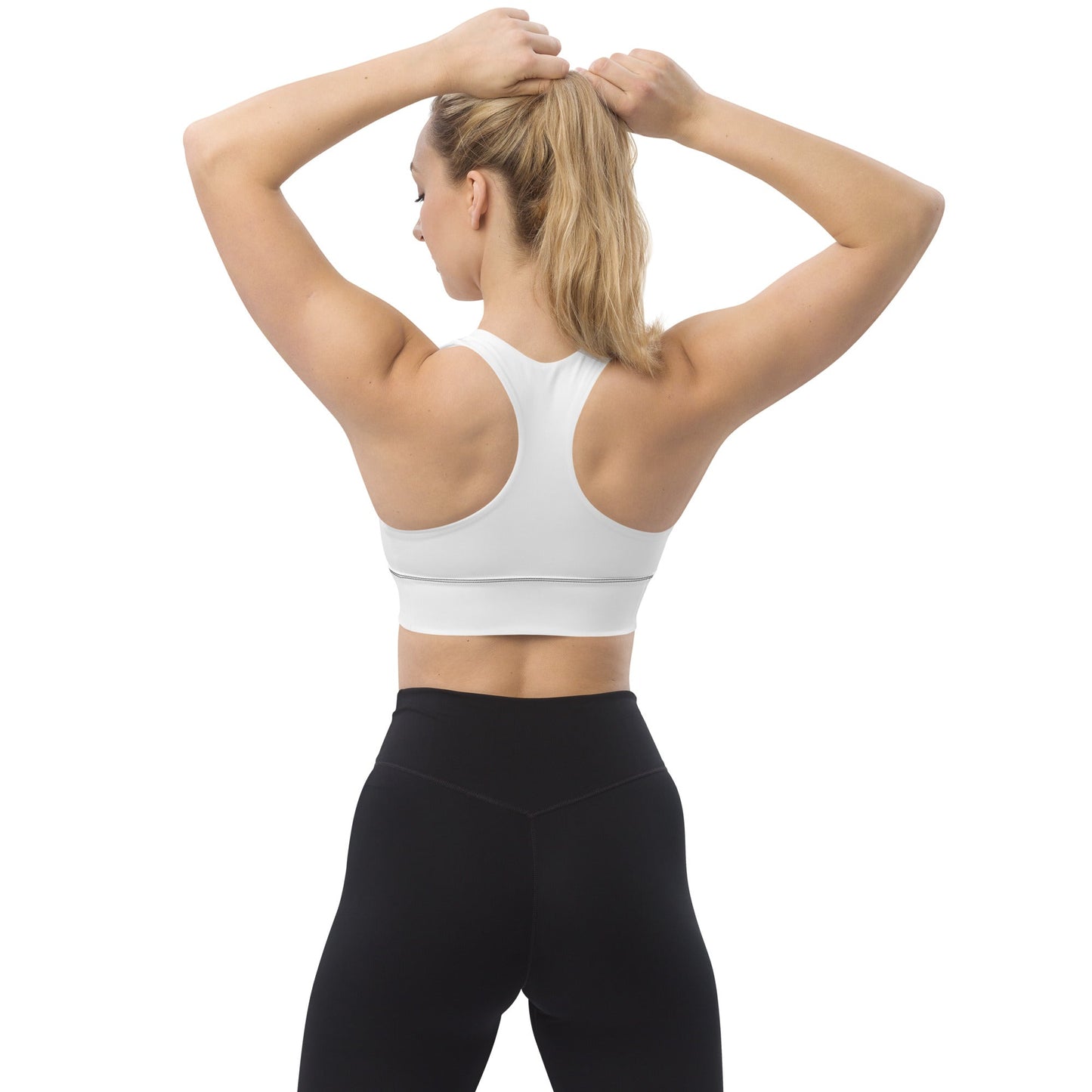 Back view of woman wearing white KALLISTII activewear sports bra and black leggings