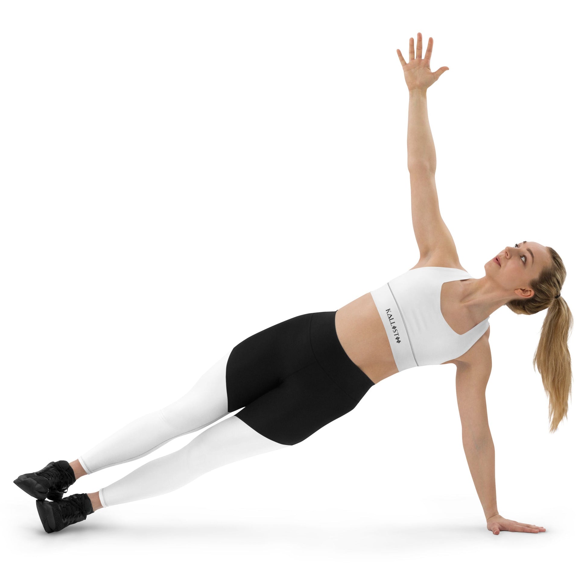 Woman doing side plank wearing KALLISTII activewear sports bra white and black leggings