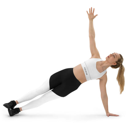 Woman doing side plank wearing KALLISTII activewear sports bra white and black leggings