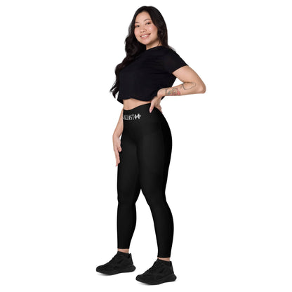 Woman wearing KALLISTII high waisted leggings in black with a black crop top and sneakers