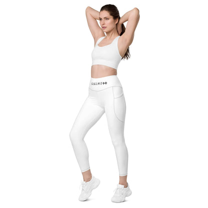 Woman wearing white KALLISTII high waisted leggings with side pockets and white sports bra