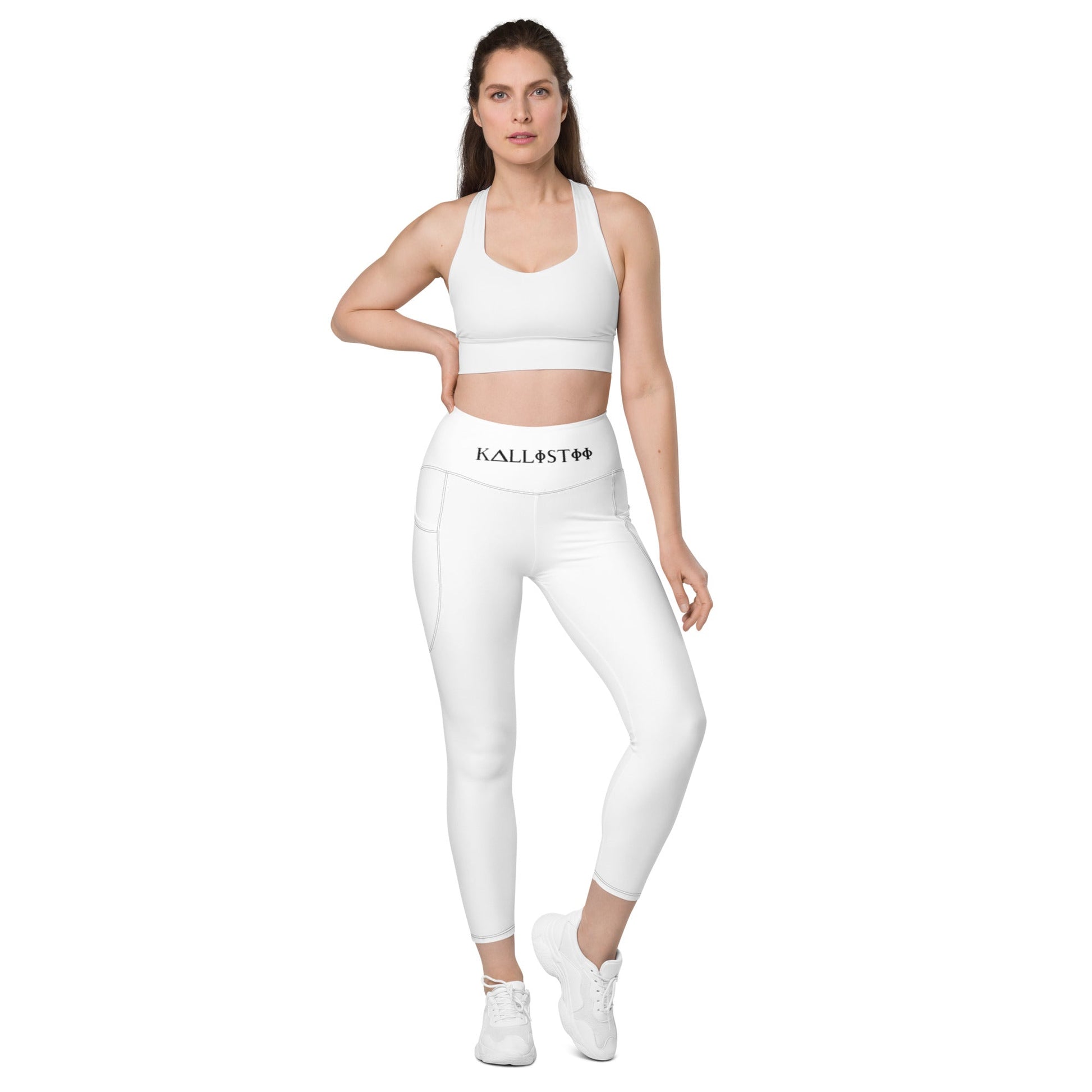Woman wearing white KALLISTII high waisted leggings with side pockets and matching sports bra