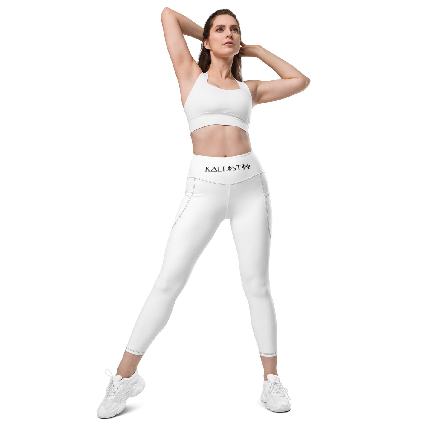 Woman wearing KALLISTII high waisted leggings in white with side pockets and a matching sports bra