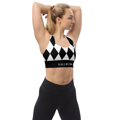 Woman wearing black and white harlequin sports bra by kallistii with black leggings stretching arms