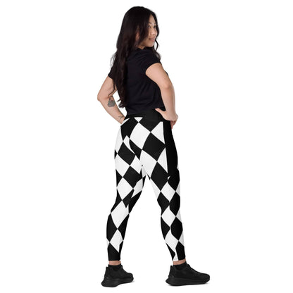 Woman wearing black and white harlequin leggings with a high waist and a black top