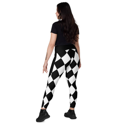 Woman wearing kallistii black and white harlequin leggings with geometric diamond pattern and black top