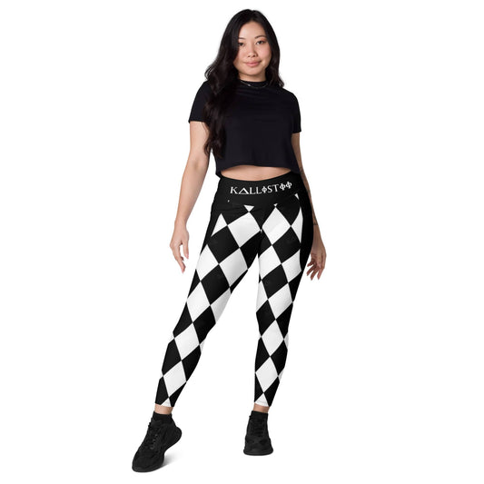 Woman wearing black and white harlequin leggings by kallistii with a black crop top and black shoes