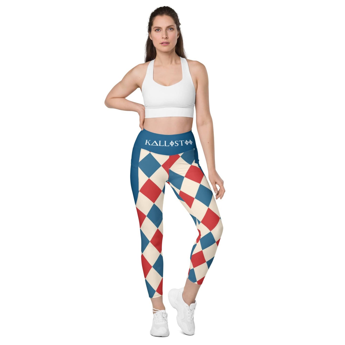Woman wearing kallistii harlequin leggings with blue, red, and cream diamond pattern and a white sports bra