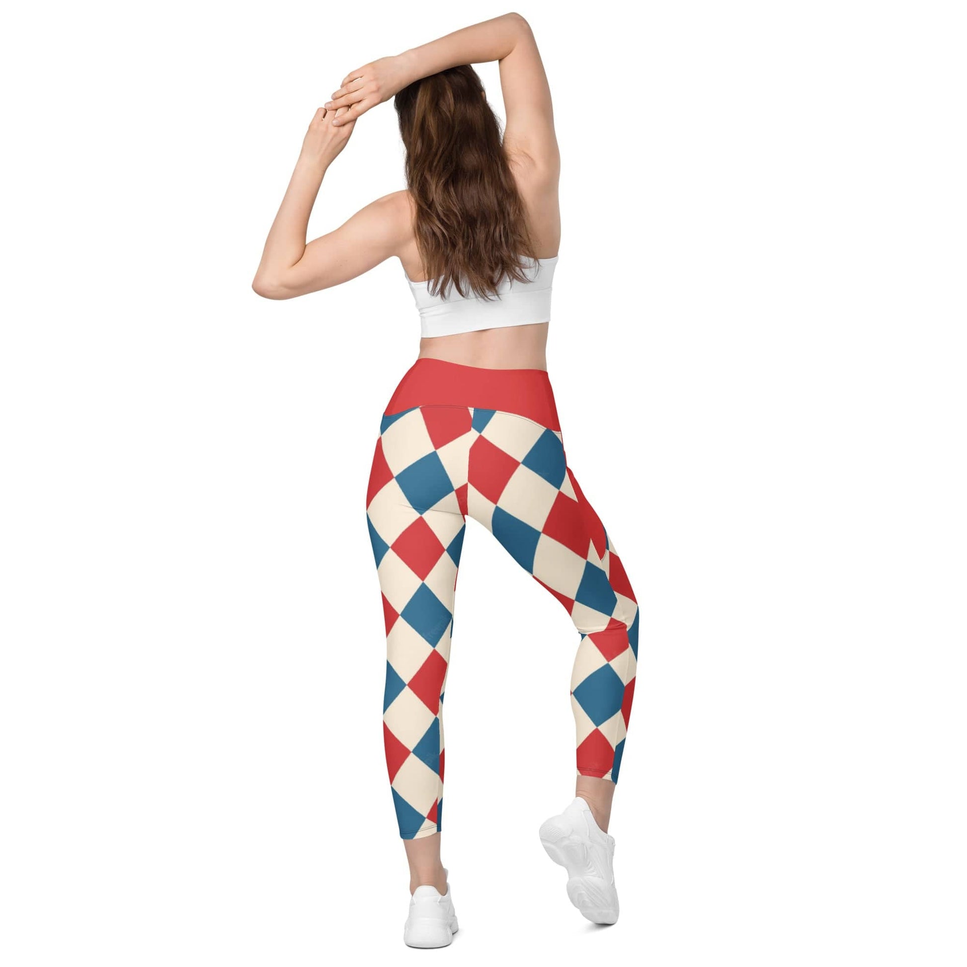 Woman wearing kallistii harlequin leggings with red, blue, and cream diamond pattern and red waistband