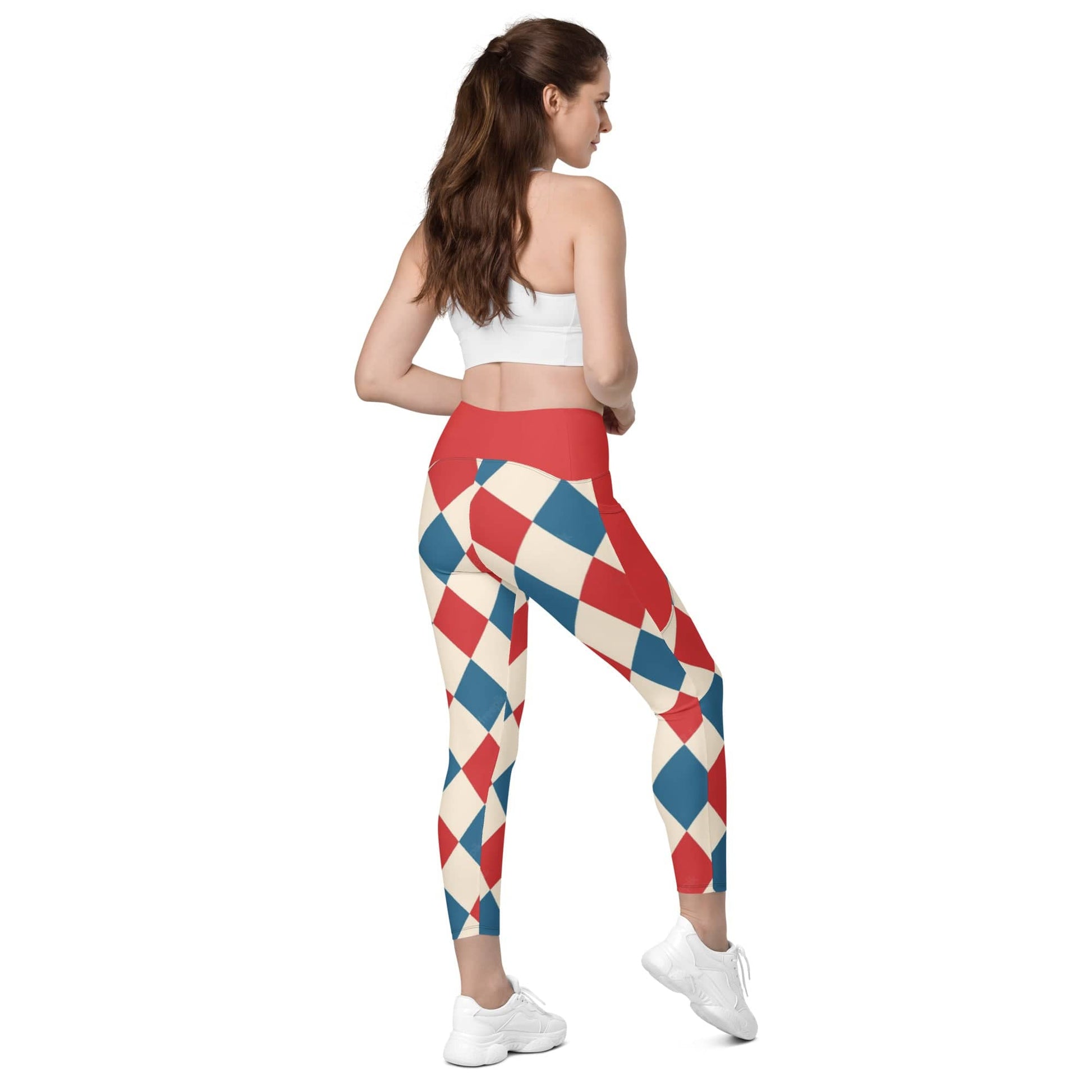 Woman wearing kallistii harlequin leggings with red blue and cream diamond pattern and red waistband