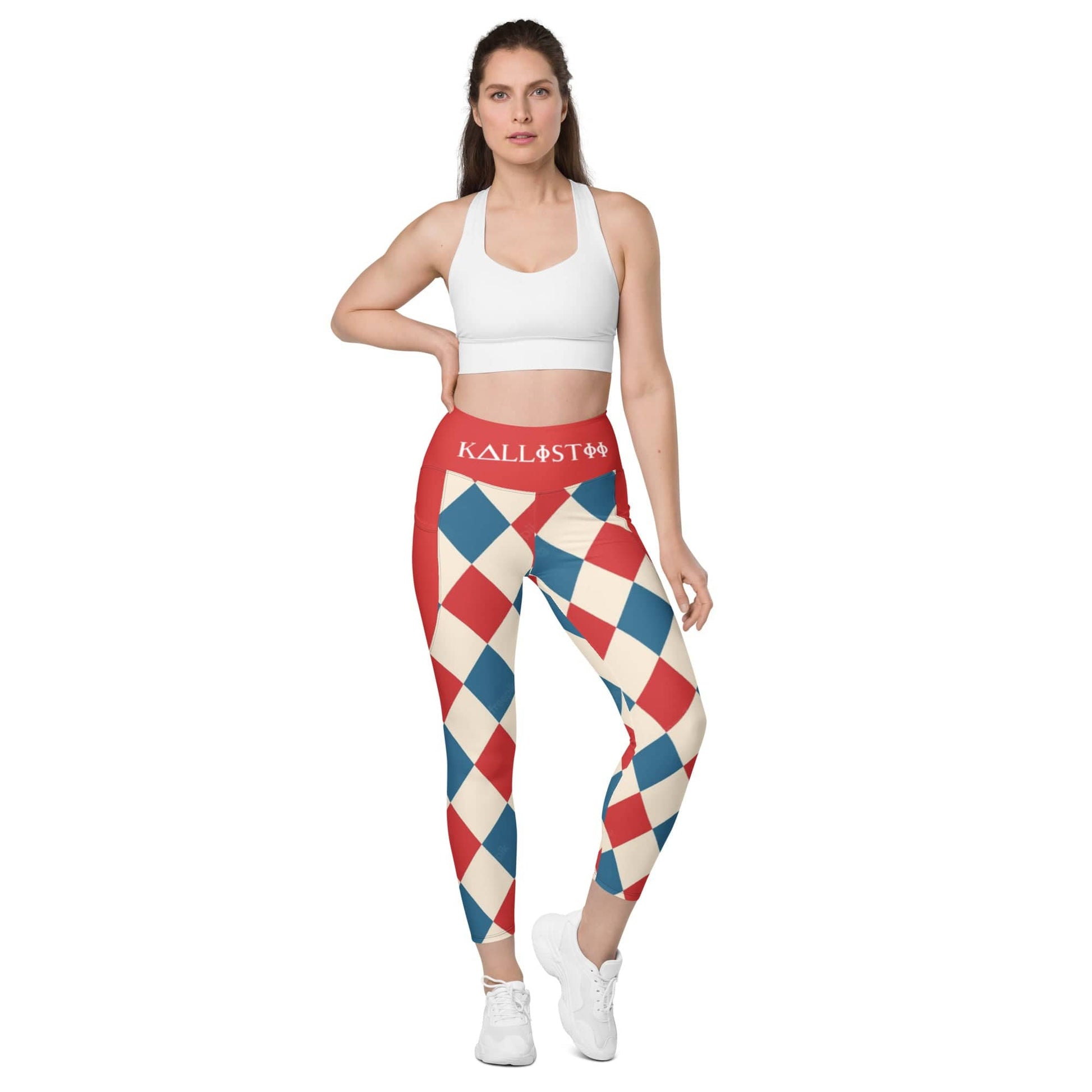Woman wearing kallistii harlequin leggings with red blue and cream diamond pattern and white sports bra