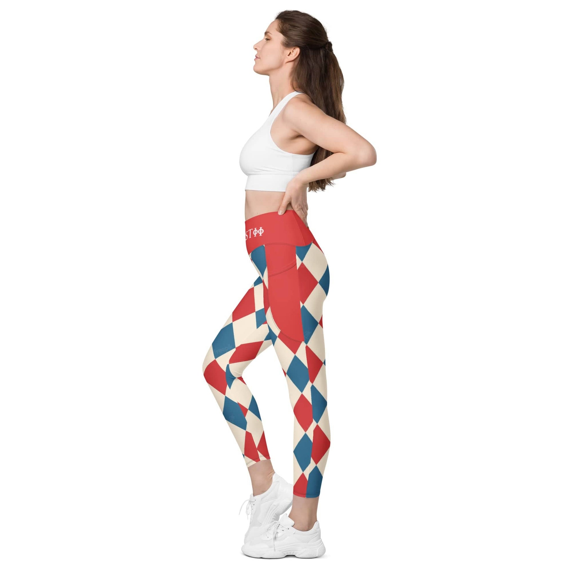 Woman wearing colorful red blue and white harlequin leggings paired with white sports bra and sneakers