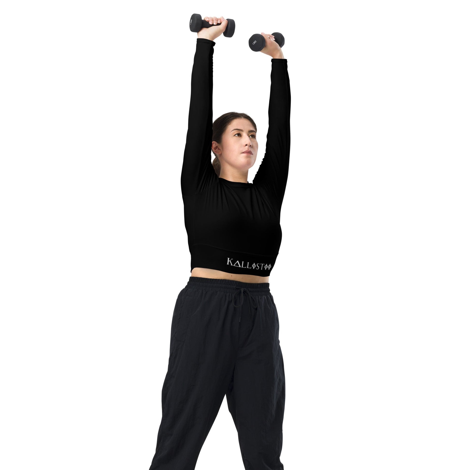 Woman wearing a unique womens workout crop top by kallistii lifting dumbbells overhead