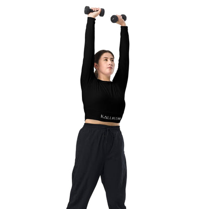 Woman wearing a unique womens workout crop top by kallistii lifting dumbbells overhead