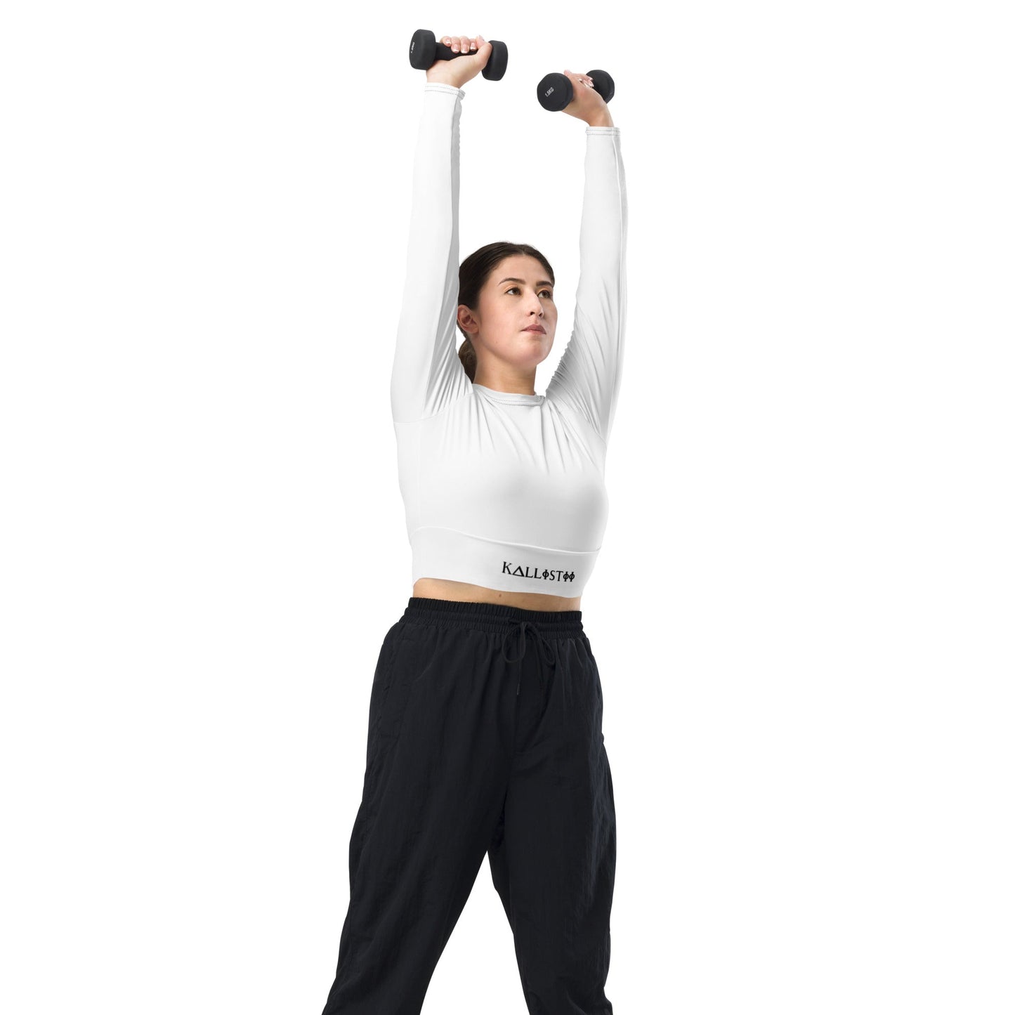 Woman wearing kallistii unique womens workout crop top in white lifting dumbbells overhead