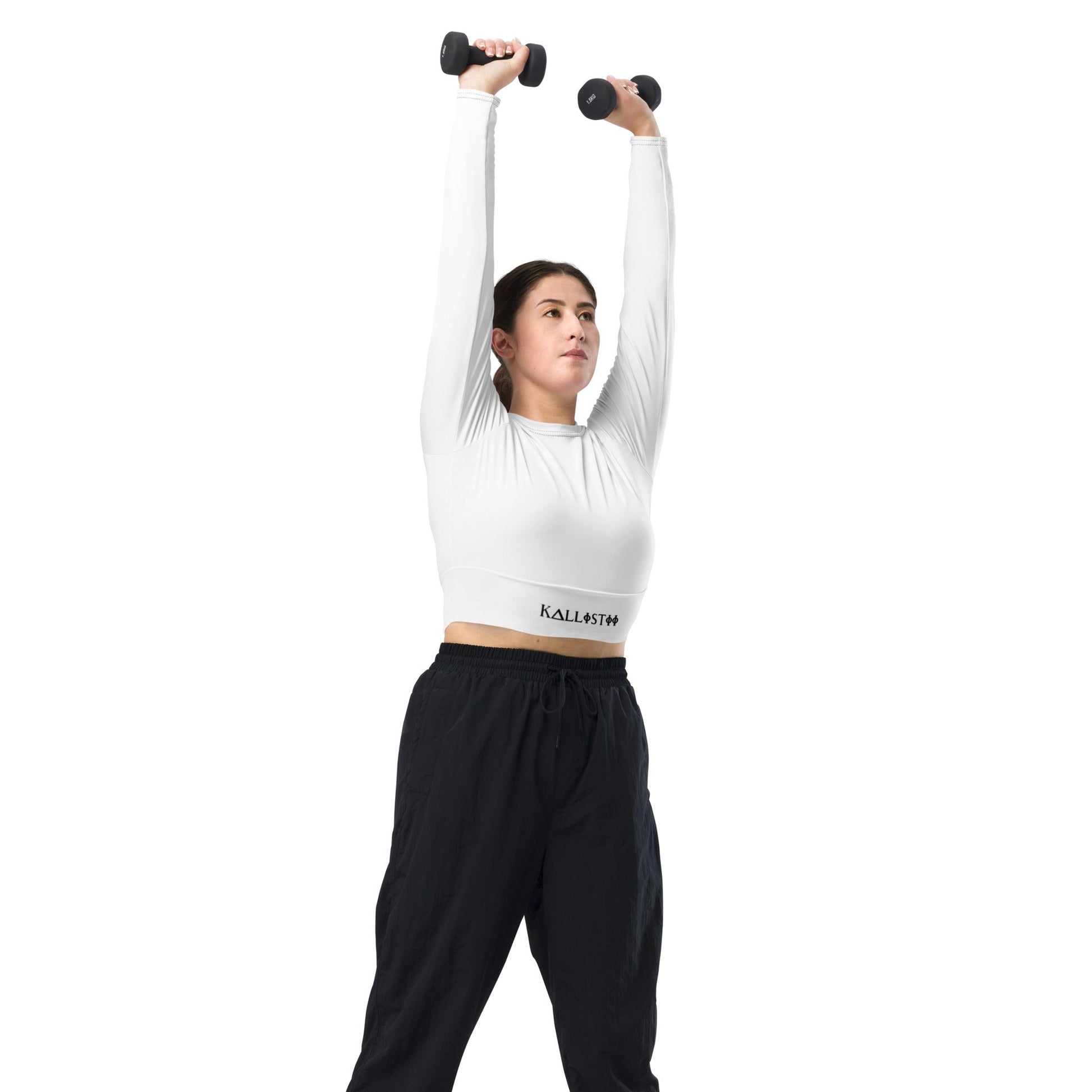 Woman wearing kallistii unique womens workout crop top in white lifting dumbbells overhead