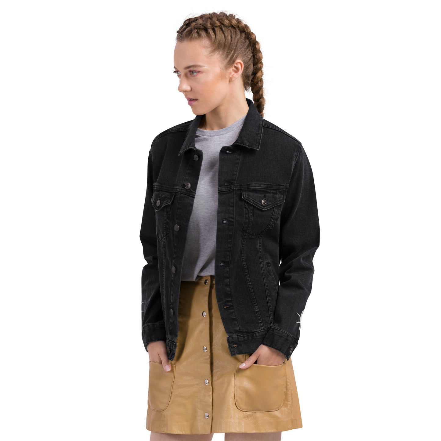Kallistii black embroidered denim jacket worn by woman with braided hair and tan skirt