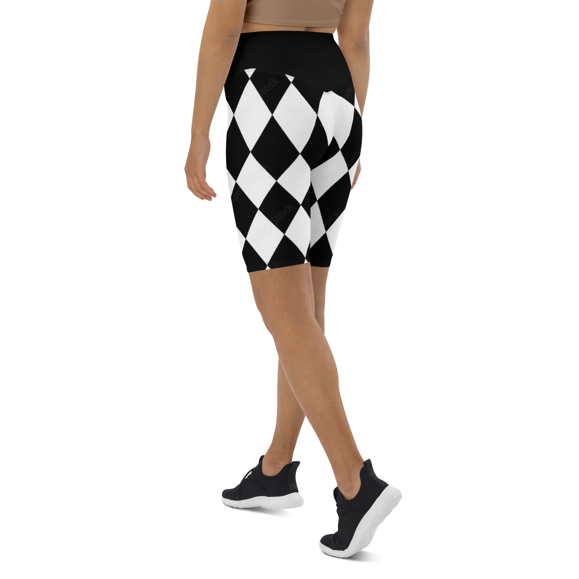 Woman wearing black and white harlequin active shorts by kallistii in a diamond pattern