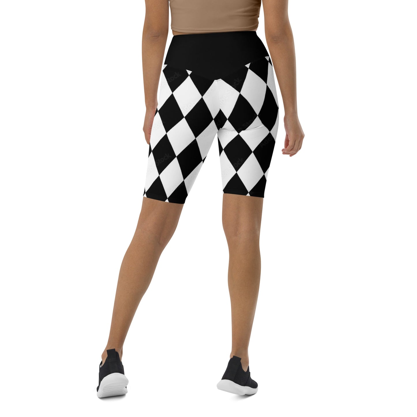 Back view of woman wearing black and white harlequin active shorts with high waist and fitted design