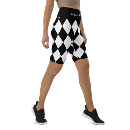 Kallistii harlequin active shorts with black and white diamond pattern worn by model in athletic pose