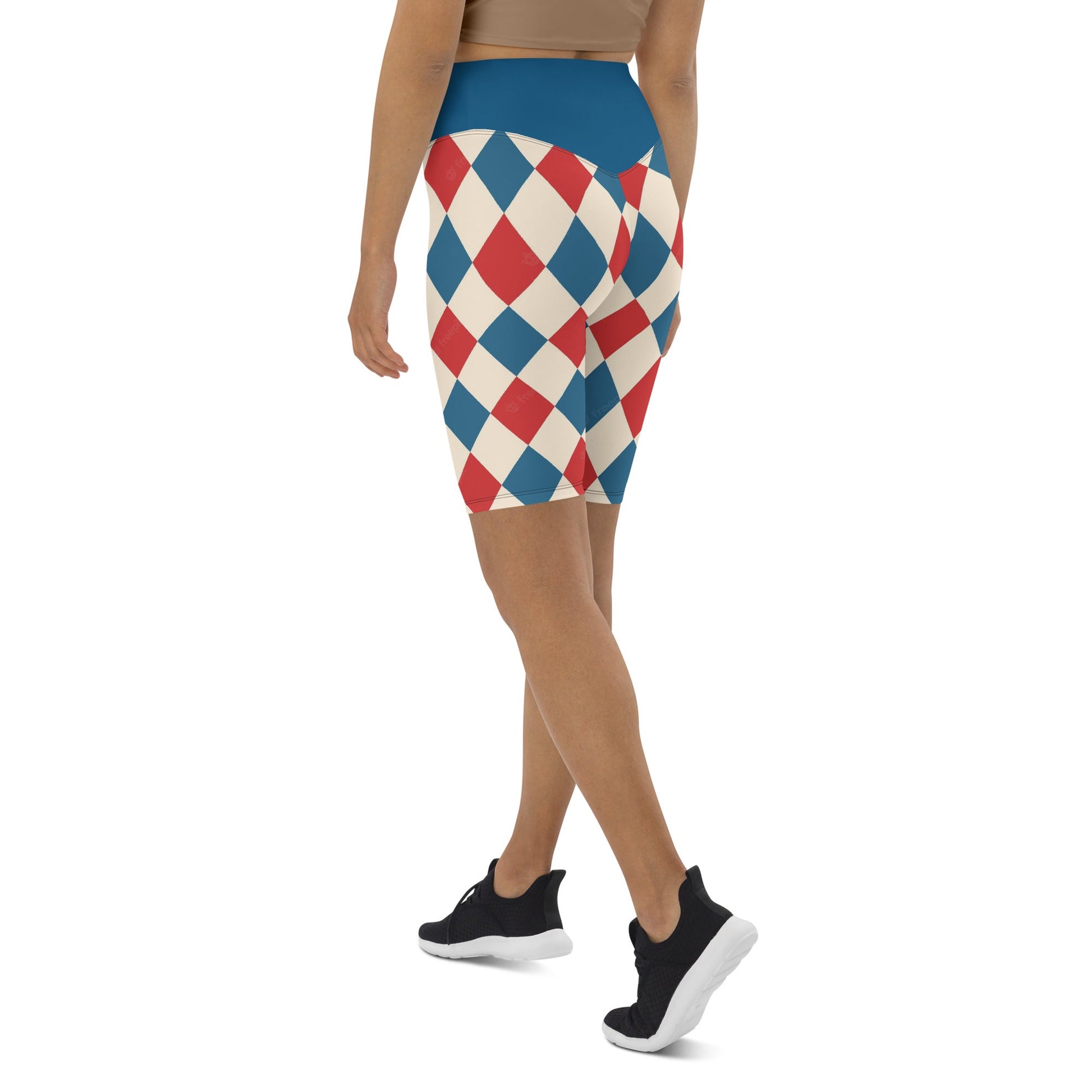 Kallistii harlequin active shorts with red blue and white diamond pattern worn by model