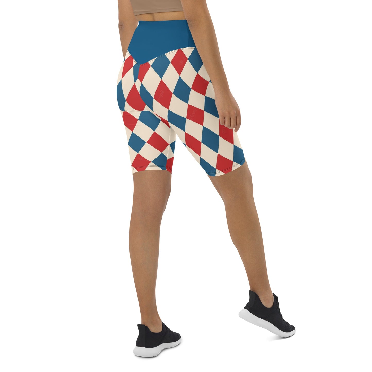 Back view of woman wearing kallistii harlequin active shorts with red blue and white diamond pattern