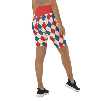 Back view of woman wearing kallistii harlequin active shorts with red and blue diamond pattern