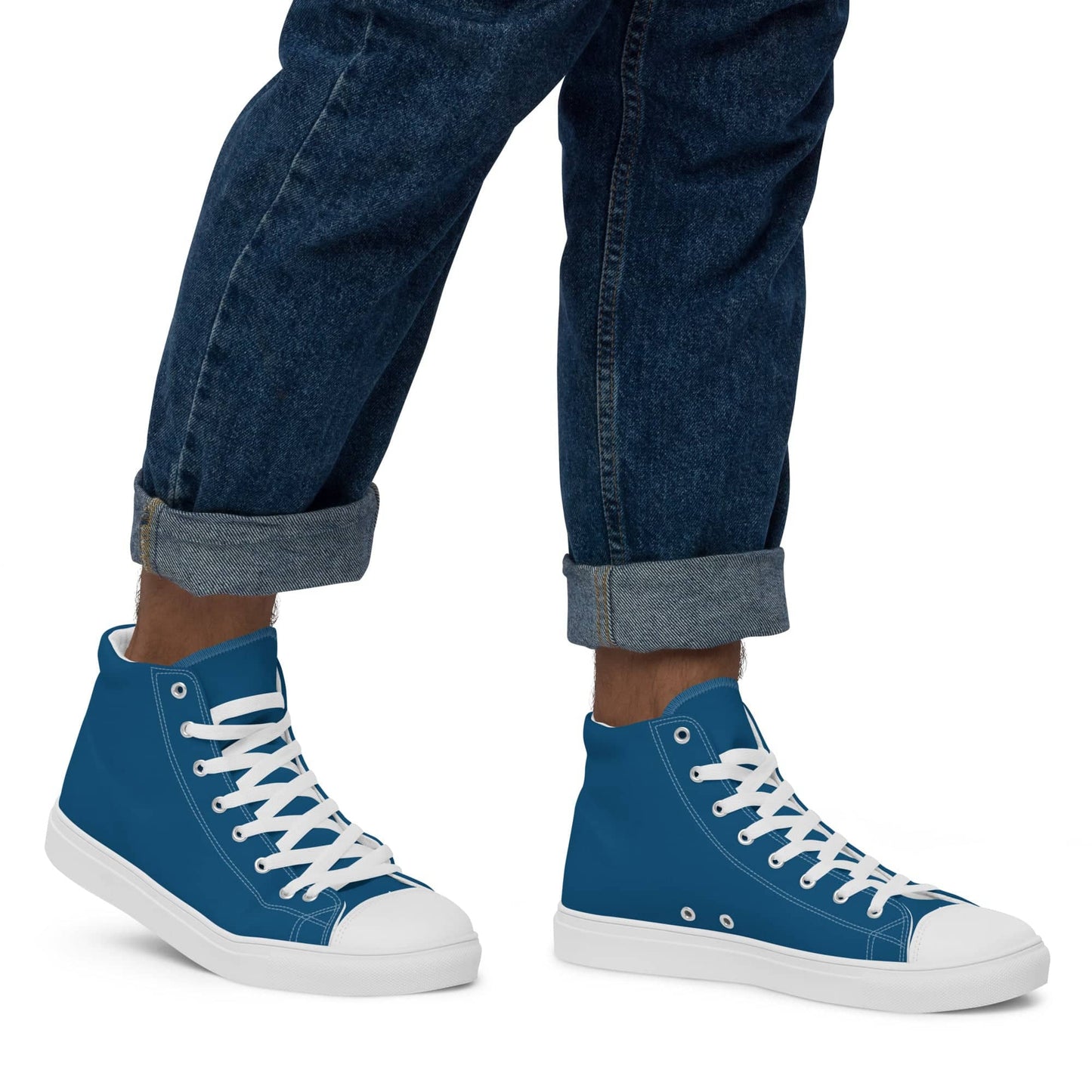 Blue high-top statement sneakers for men with white laces and soles worn with rolled-up jeans