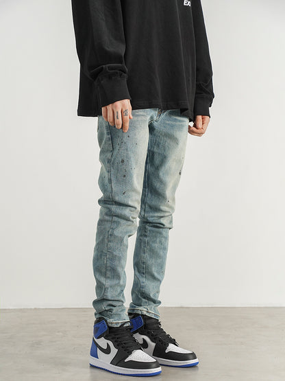 Kallistii painted effect slim fit jeans worn with black and white high-top sneakers