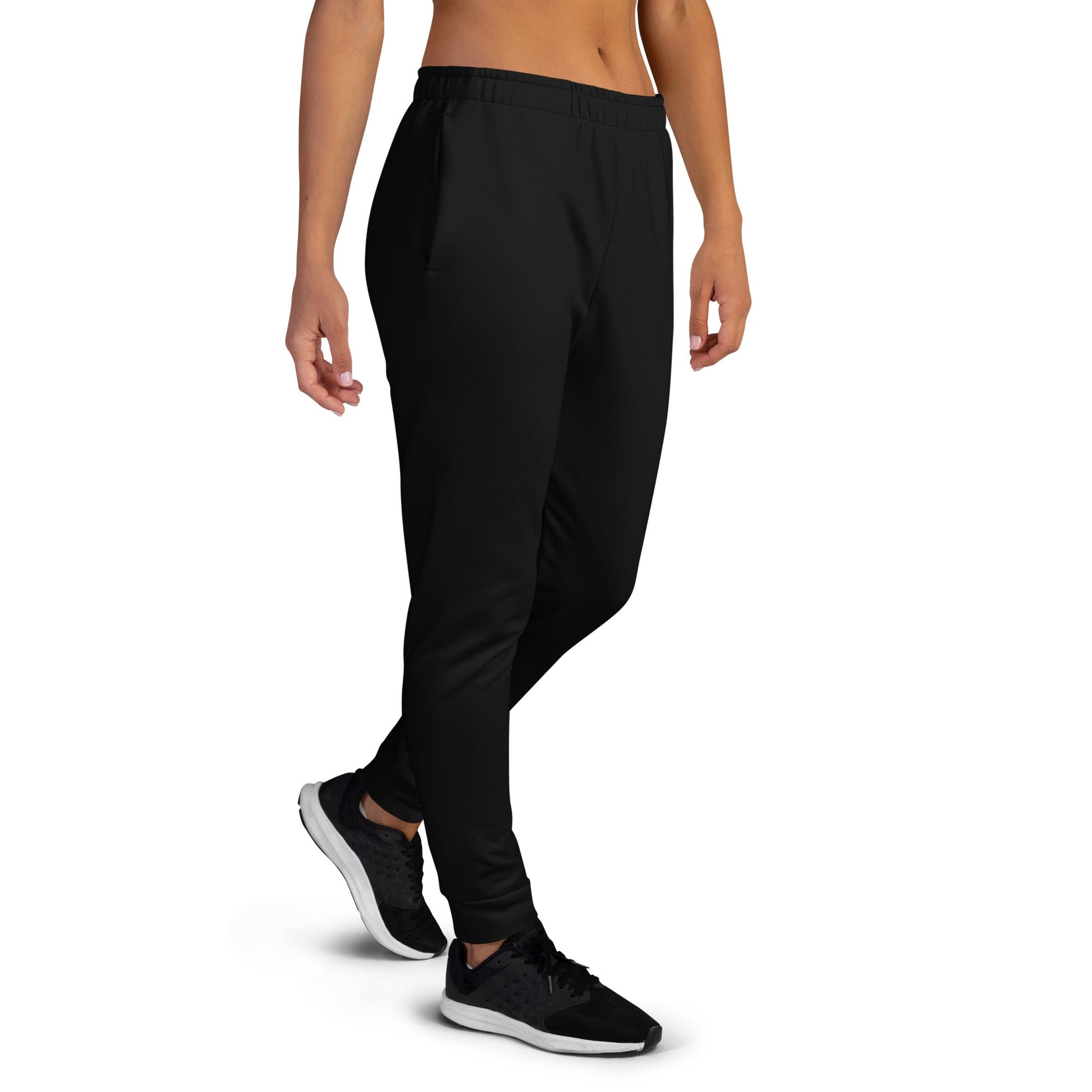 Kallistii black unique logo joggers with elastic waistband and tapered legs worn with black sneakers