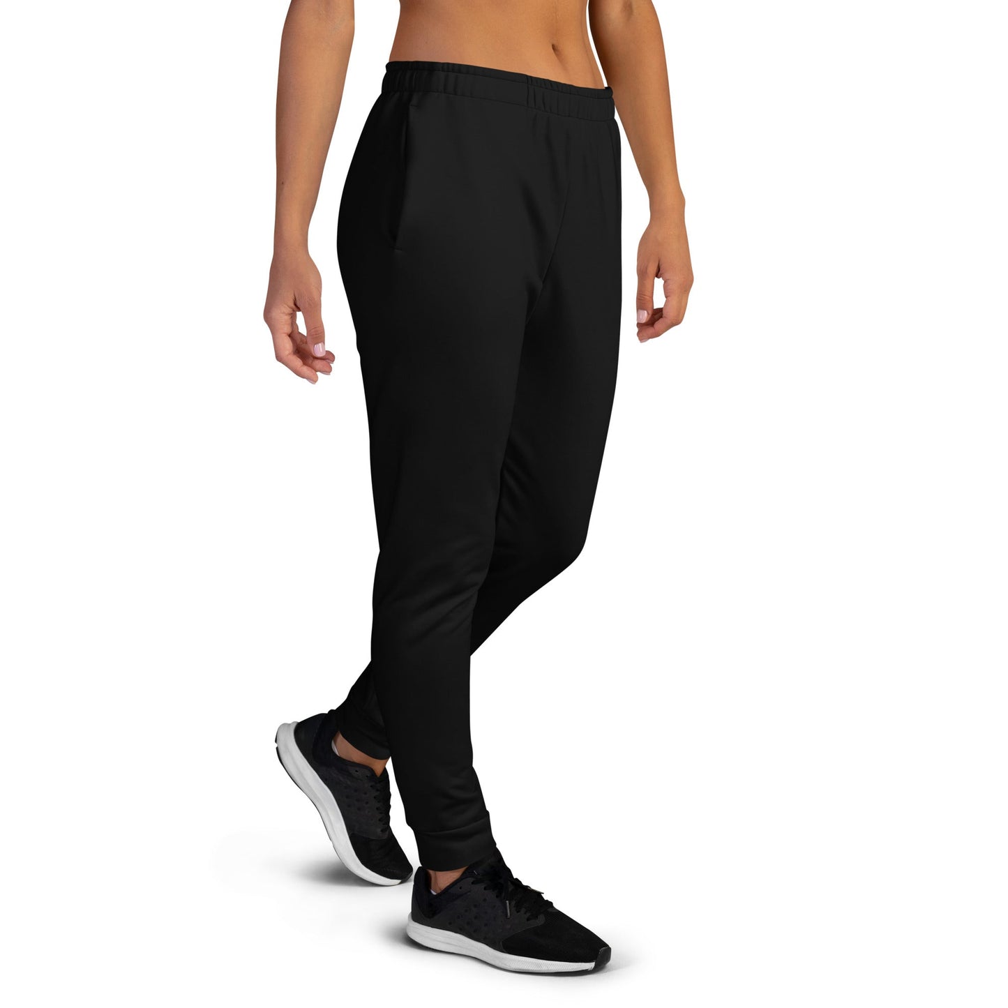 Black unique logo joggers by kallistii with elastic waistband and tapered fit worn with black sneakers