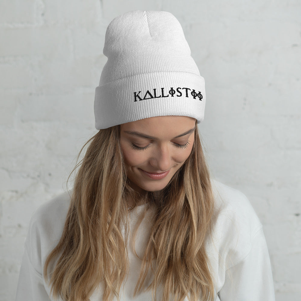 Woman wearing white KALLISTII embroidered beanie with black logo and white sweater