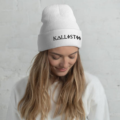 Woman wearing white KALLISTII embroidered beanie with black logo and white sweater