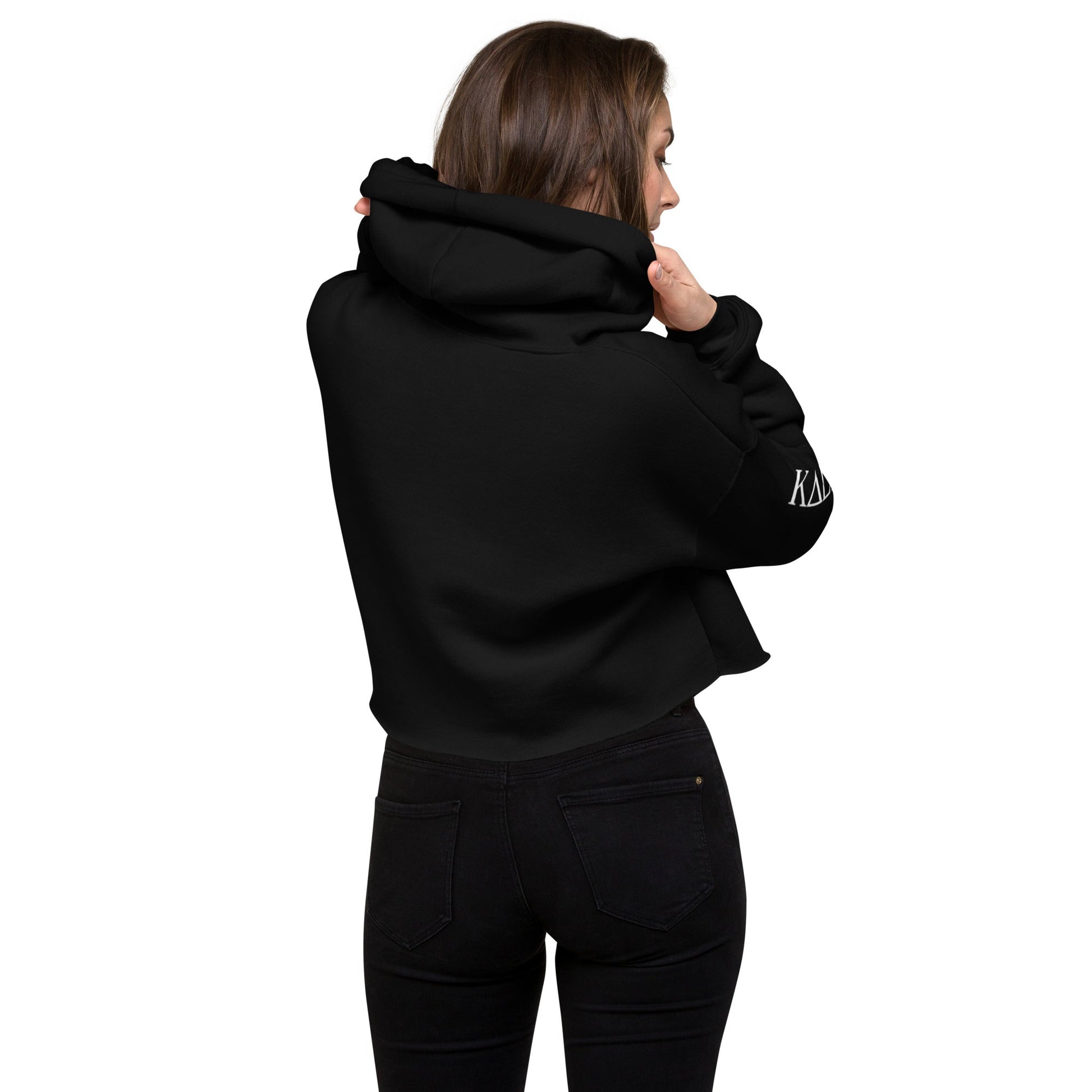 Kallistii womens fashion crop hoodie in black shown from the back on a model wearing black jeans