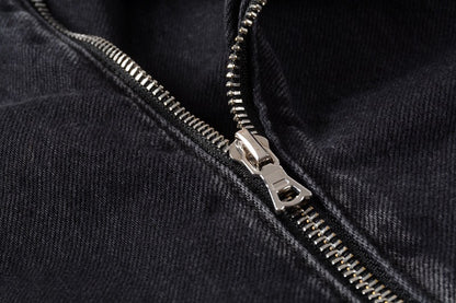 Close-up of silver zipper detail on black denim motorcycle jacket by kallistii