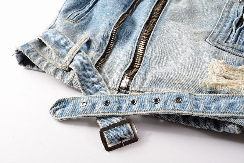 Close-up of blue denim motorcycle jacket with metal zipper and adjustable belt buckle by kallistii
