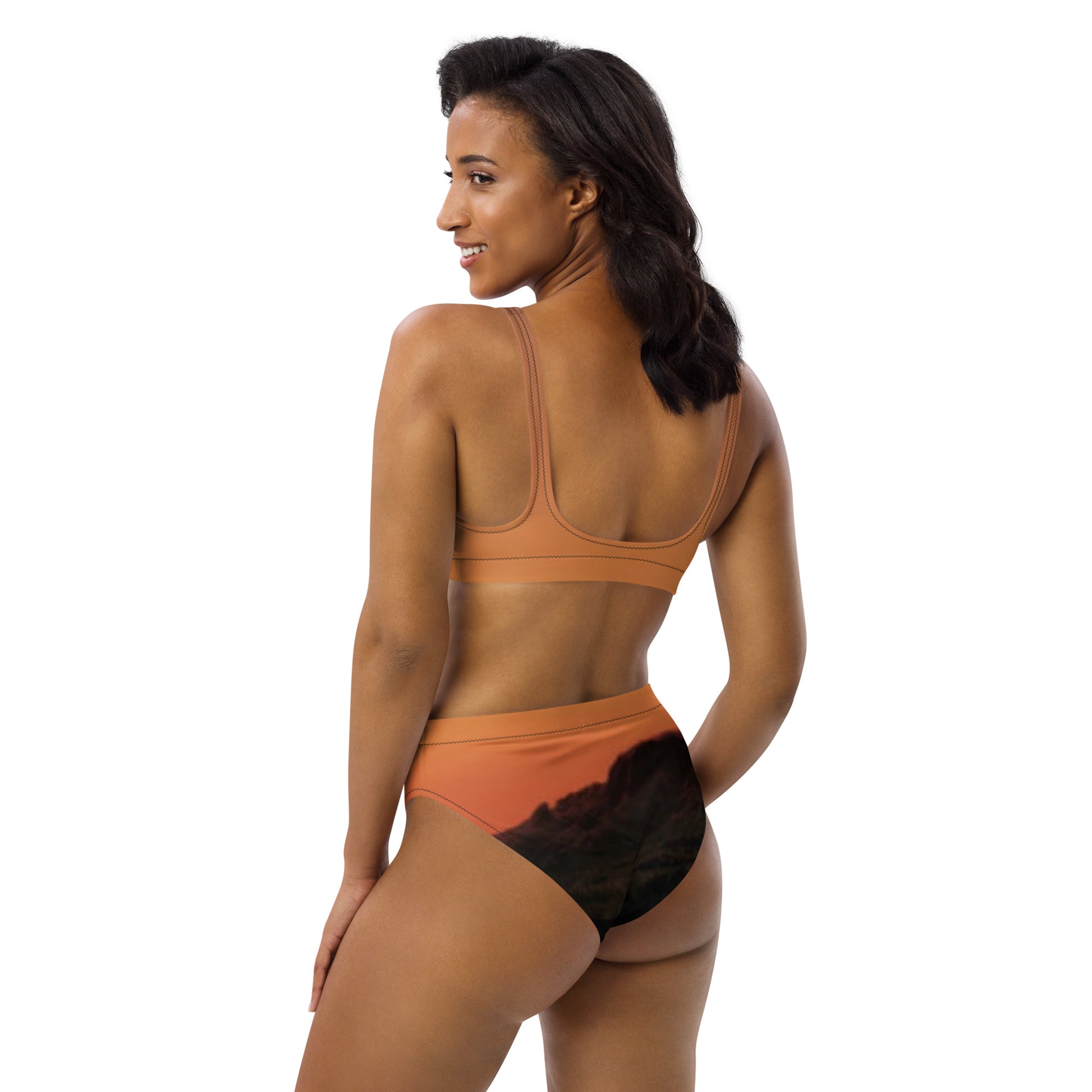 Woman wearing Mesa bikini set unique design in earthy tones showing back view with landscape print bottoms