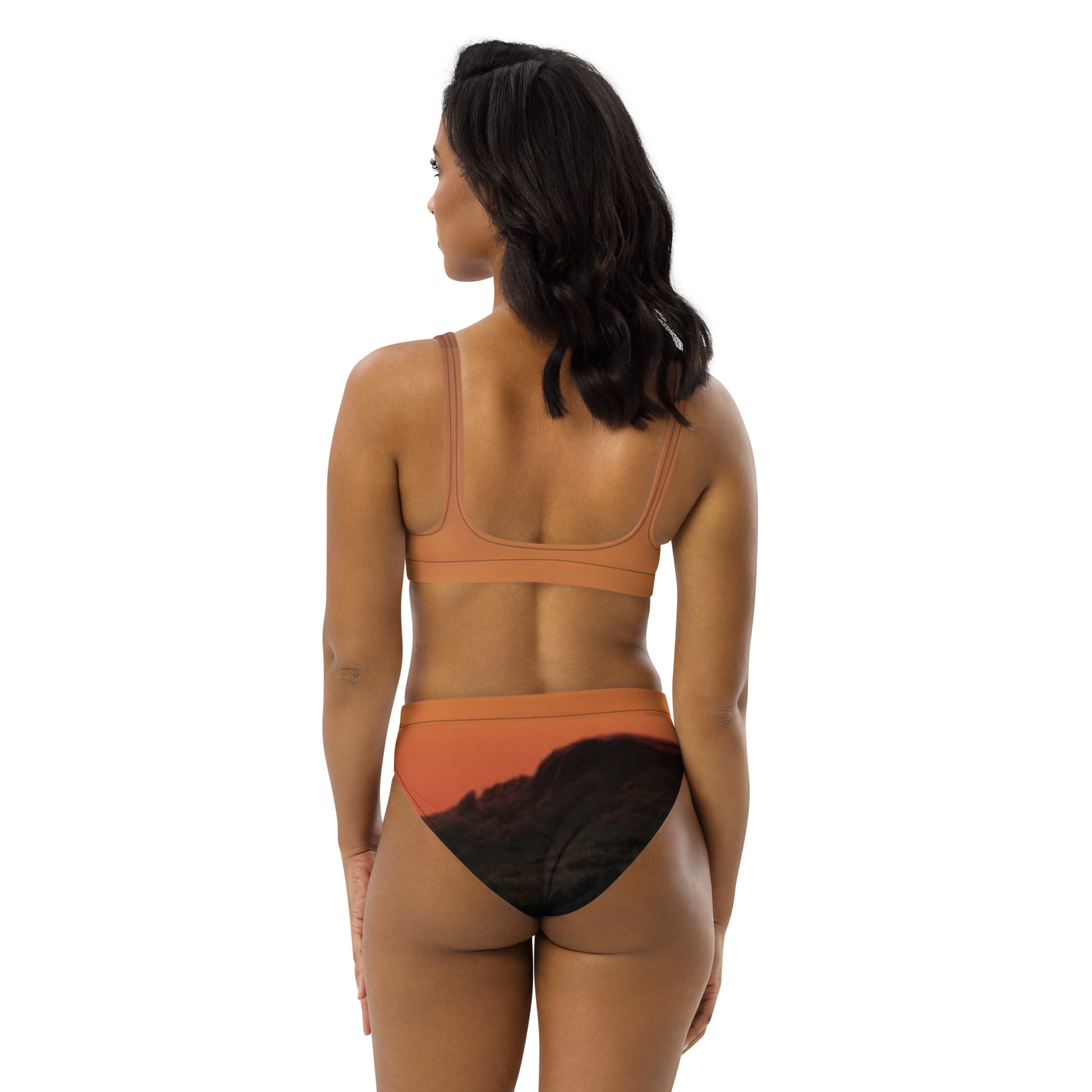 Back view of woman wearing Mesa bikini set unique design in orange with black mountain print bottoms